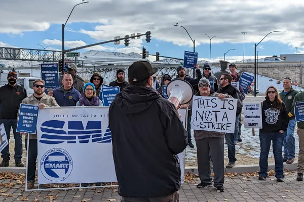 Gabe Christenson speaks to a crowd rallying for rail