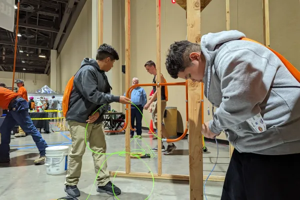Kids practice running electrical through conduit at Construction Career Day 2022 in Reno, Nevada.