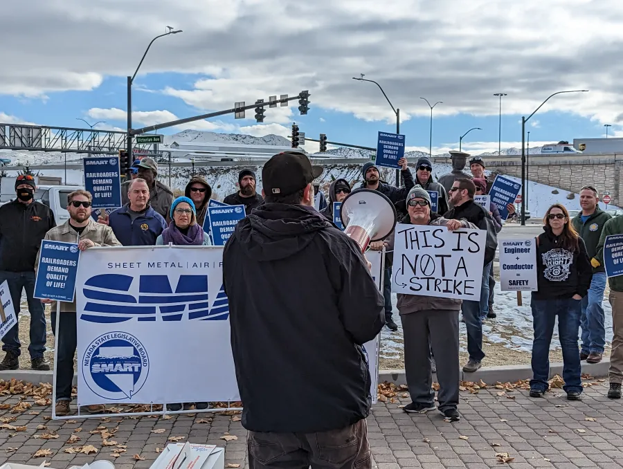 Gabe Christenson speaks to a crowd rallying for rail